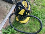 une photo d'un sèche-cheveux jaune et noir posé par terre à côté d'une porte