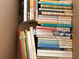 a box full of books that are stacked on top of each other