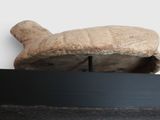 a stone object that is on a shelf in a room