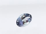 an oval blue sapphire stone on a white background
