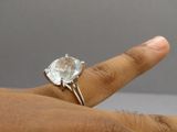 an image of a person ' s hand with a ring on it