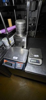a picture of a kitchen with a scale and a kettle