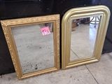 deux miroirs à cadre doré posés sur le comptoir d'un magasin
