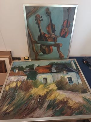 a picture of a painting on a table next to a picture of a guitar