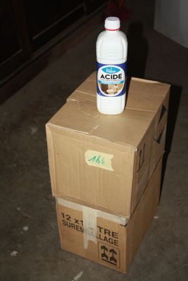 boxes stacked on top of each other with a bottle on top of them