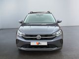 the front of a grey volkswagen suv parked in a white room