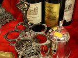 bottles of wine, a brush and a bottle of wine on a table