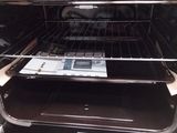 an open oven with two trays of food inside of it