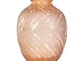 a glass vase that is sitting on a white surface