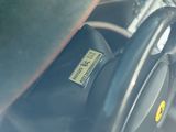a close up of a steering wheel with a sticker on it