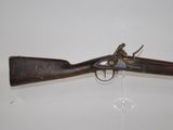 a close up of a gun on display on a white surface