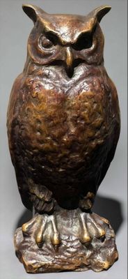 an image of a statue of an owl sitting on top of a tree stump