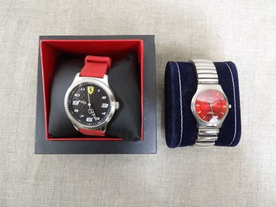 a red watch and a black watch in a box