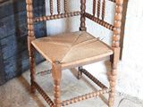 a wooden chair that is sitting in front of a door