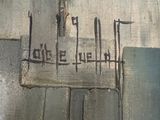 graffiti on the side of a building with a sign that says love is in the air