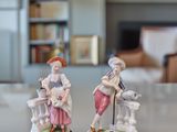 two figurines sitting on a table in a living room