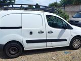 a white van parked in a parking lot next to other cars