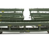 three green train cars sitting next to each other on a white surface