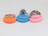 three different colored rings sitting on top of each other on a white surface
