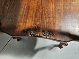 a wooden table with a metal handle on it