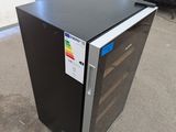 an image of a small black refrigerator in a garage