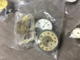 many different types of clocks in the bag on the table