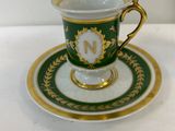 a close up of a cup and saucer on a table