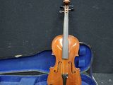 a violin and a violin case on the floor