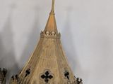 two gold colored lanterns with crosses on them