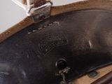 a close up of a brown purse with a brown handle