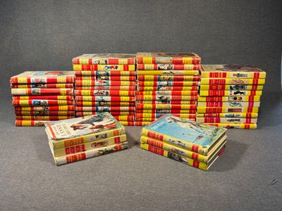many books stacked on top of each other on a table