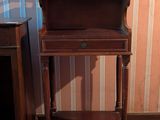 a small wooden table with a drawer on top of it