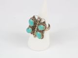a close up of a ring with turquoise stones on it