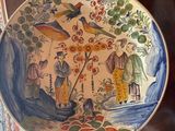 une assiette avec une peinture posée sur une table