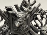 a clock that has a statue of a deer and guns on it