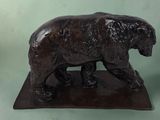 a statue of a bear that is standing on a base