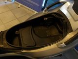 a motor scooter that is sitting on the floor
