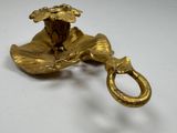 brass plate with a flower on it on a white surface