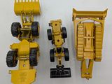 two toy trucks that are sitting next to each other