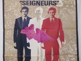 L'affiche du film « La Race des Seigneurs » est accrochée au mur.