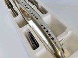 a silver pen in a white box with a pen in it