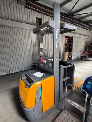 a yellow forklift truck parked in a warehouse