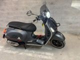 a scooter that is parked on the side of the street