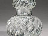a clear glass jar with a swirly design on it