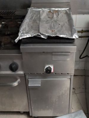 a stove with a pan on top of it in a kitchen