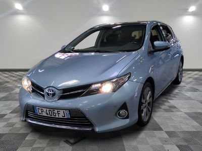 a picture of a blue toyota corollant parked on a checkered floor