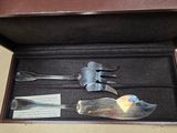 a box with a knife, fork and spoon inside of it