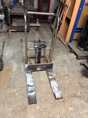a fork lifter sitting in the middle of a warehouse