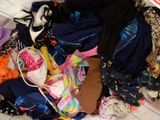 a pile of clothes that is on a bed