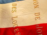 a red, white, and blue flag with words on it